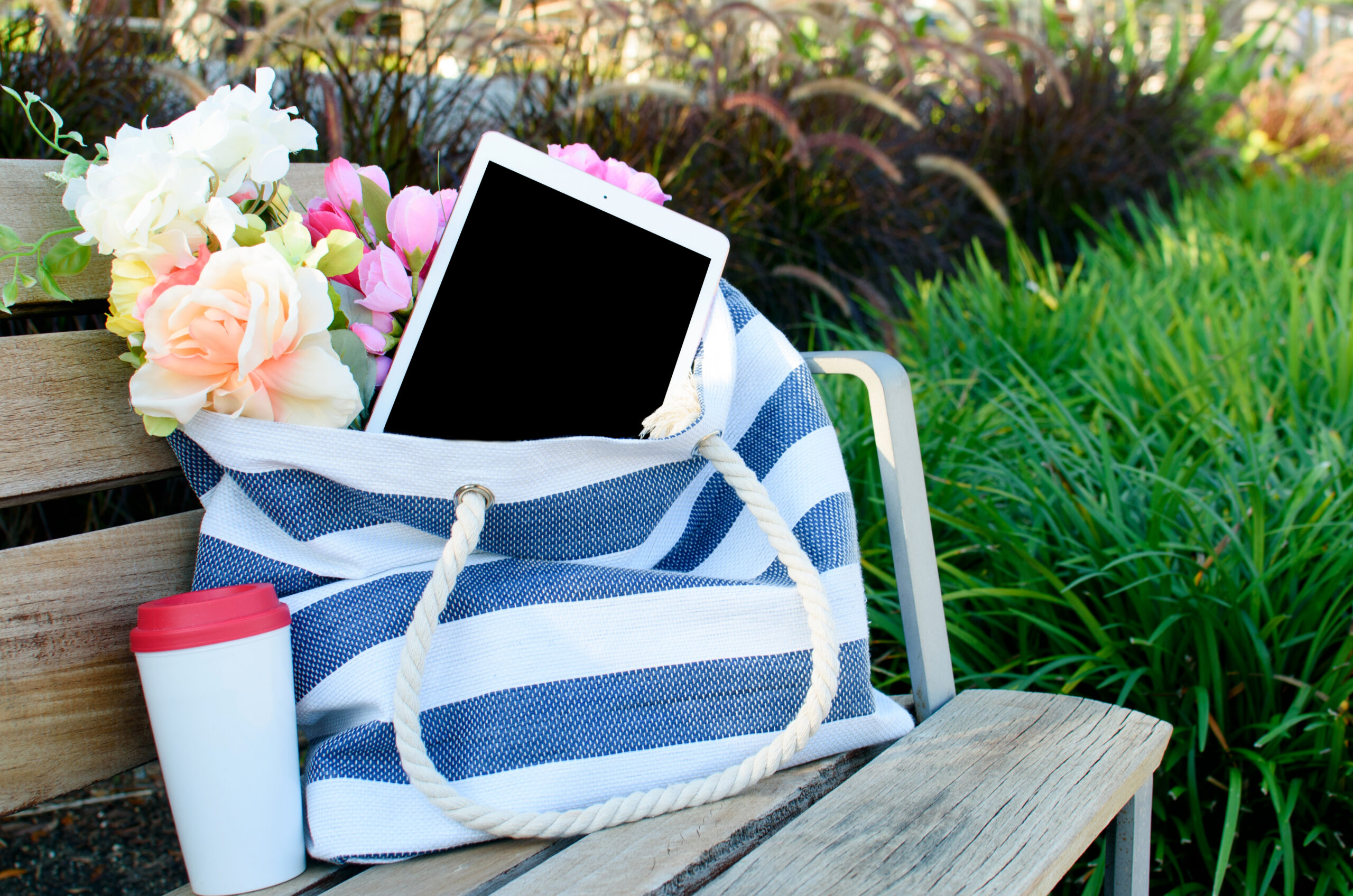 White ipad with black screen in tote bag